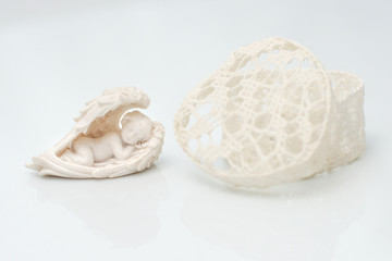 Heart shaped box on a white background at an angel figurines