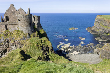 Fototapeta na wymiar Dunluce Castle (Irish: Dun Libhse), a now-ruined medieval castle located on the edge of a basalt outcropping in County Antrim, Northern Ireland