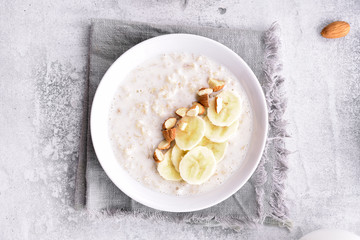 Oats porridge with banana slices and nuts