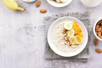 Healthy breakfast oats porridge with banana slices