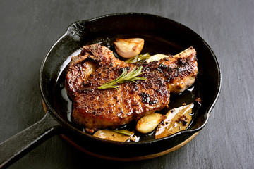 Grilled pork steak in frying pan