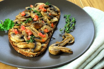 fried white mushrooms with bread and greens