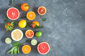 Fruit background. Colorful fresh fruits on black background. Orange, tangerine, lime, lemon, grapefruit. Flat lay, top view, copy space