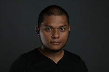 man using gadget with different expression in gray background