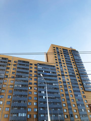 View of blue sky and orange building. Concept of construction. Moving up. Straight lines.