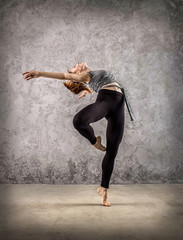 Fototapeta na wymiar Woman dancer, in beautiful dynamic jump action figure on the gru