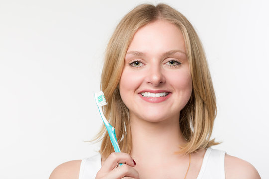 Junge lächelnde Frau mit einer Zahnbürste
