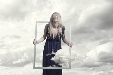 surreal image of a woman who tries to free herself and run away from the frame that contains her