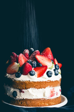 Sponge cake with strawberries, blueberries and cream