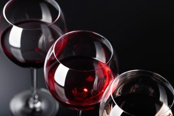 Glasses of  pink , red and white wine .