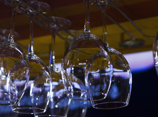 The empty clean glasses in bar, upside down, close up