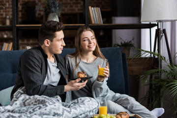 couple having breakfast in bed in morning