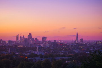 View towards London city skyline at sunrise from Parliament Hill in Hampstead Heath