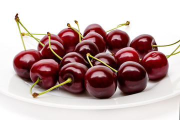 Cherry berries on a white plate isolated on white background cutout