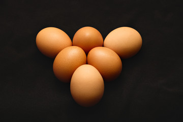 Chicken eggs on a black background. Close up