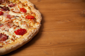 Close-up Delicious Italian pizza with ham, cherry tomatoes and parmesan, Top view. Place for text