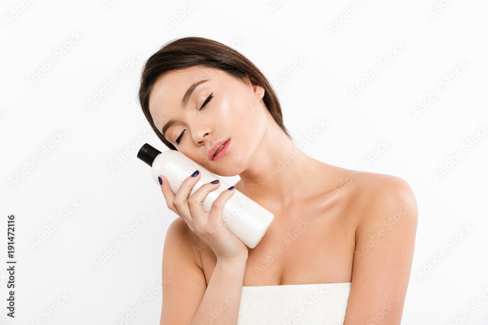 Canvas Prints beauty portrait of beautiful asian woman with closed eyes holding body lotion in her hand, isolated 