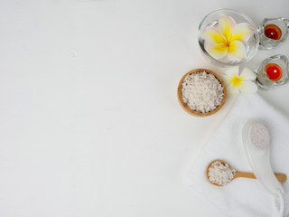 spa wellness set.beauty and fashion set on the white table.spa towel with candle and plumeria, tree on the white table.