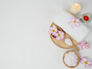 Fototapeta na wymiar spa wellness set.beauty and fashion set on the white table.spa towel with candle and plumeria, tree on the white table.