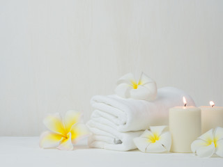 Obraz na płótnie Canvas spa wellness set.beauty and fashion set on the white table.spa towel with candle and plumeria, tree on the white table.