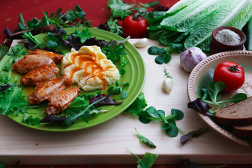 fried chicken wings with potato puree, sprinkled with sweet paprika sauce.