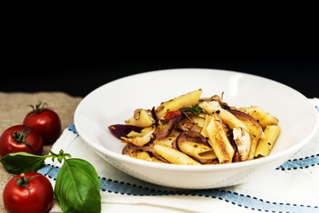 Pasta with pesto sauce and nuts on a the table