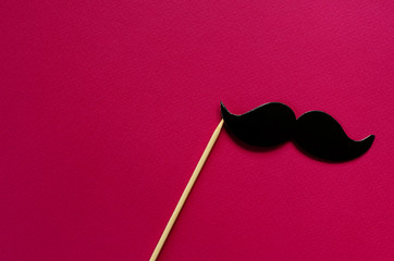 photo props - black paper mustache on pink  background