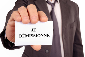 Homme tenant une carte sur laquelle est &eacute;crit je d&eacute;missionne