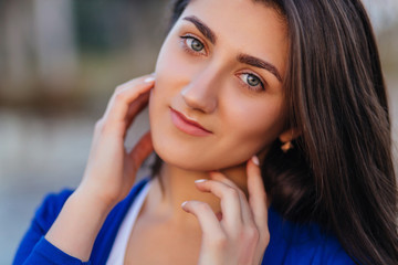 Fototapeta premium The beautiful girl stands in the center of town