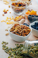 Close up of dried fruits, nuts and seeds in glass bowls