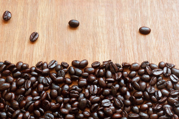 Roasted coffee beans on red-grey wooden background