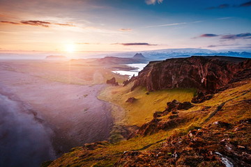 Amazing black sand of lava in the beach. Location, cape Dyrholaey, Iceland.