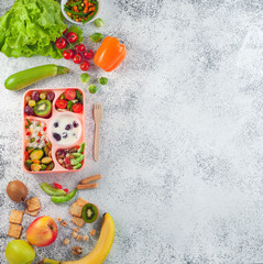 Open lunch box with healthy lunch on grey background with copy space