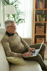 Aged man with computer