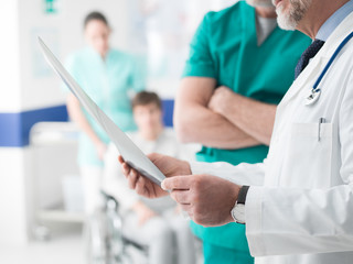 Professional doctors examining patient's x-ray