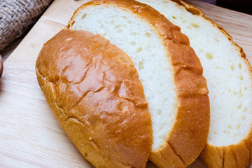 Sliced bread on wooden background.