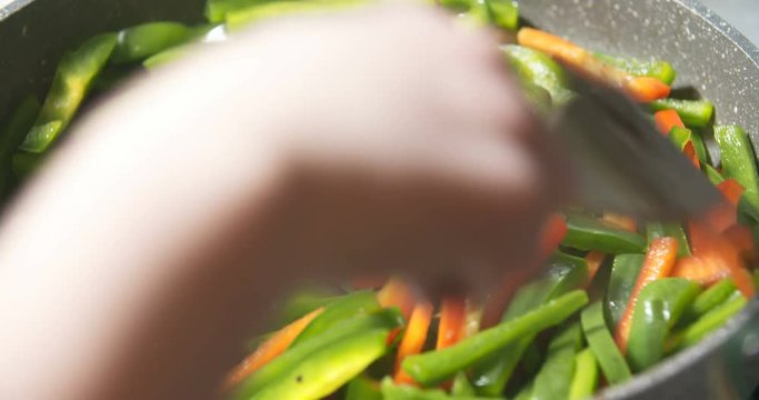 frying green and red pepper on pan