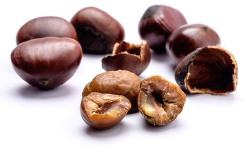 Roasted chestnuts on a white background.