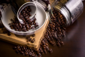 Busy coffee shop with spilt coffee beans on table - dual exposure showing movement