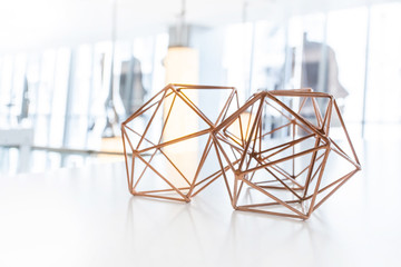 Geometric shaped table decorations on a white table. Wire frame table decorations.