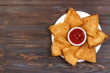 Crepes on a plate with raspberry jam for a breakfast top view with copy space