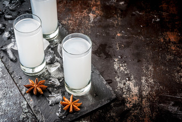 Traditional arabic alcohol drink Raki with anise, dark rusty background copy space