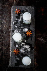 Traditional arabic alcohol drink Raki with anise, dark rusty background copy space top view