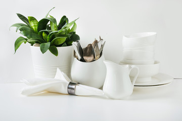 White tableware for serving. Crockery,dish, utensils and other different white stuff on white...