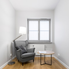 Grey armchair with small table