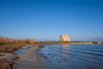 XVI Century antique defensive tower Torre Guaceto along the coast of Apulia. Italy