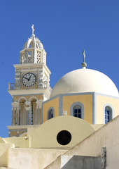 Fototapeta na wymiar Eglise de Santorin et son clocher avec croix et horloge, Grêce