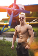 A guy is standing by the plane.