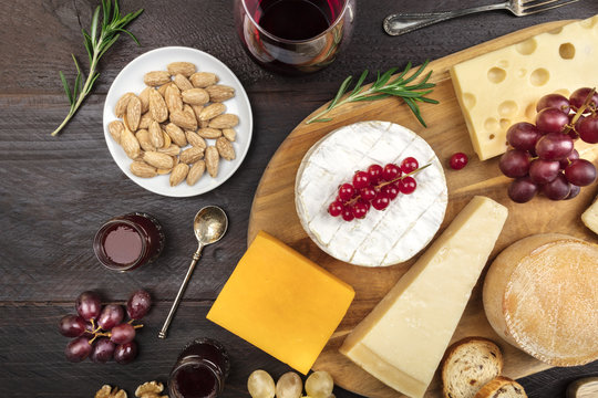 Various types of cheese on rustic background with copyspace