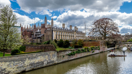 Fototapeta na wymiar Cambridge, United Kingdom - Apr 17, 2016 : People punting on the river Cam with Clare College and Clare Bridge in background